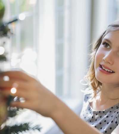 Cute little girl decorating Christmas tree Cute little girl decorating Christmas tree